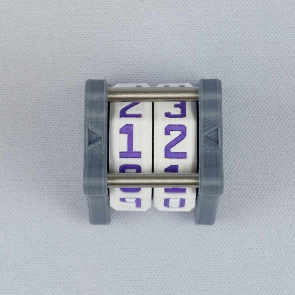 The NC-2 number counter viewed from the top to show the two dials. The version shown has a dark gray base and a pink heart in the middle on both sides 1 and 2.