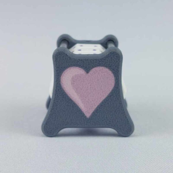 The NC-3 number counter viewed from the left side 1 to show the castle image. The version shown has a dark gray base and a pink heart in the middle on both sides 1 and 2.