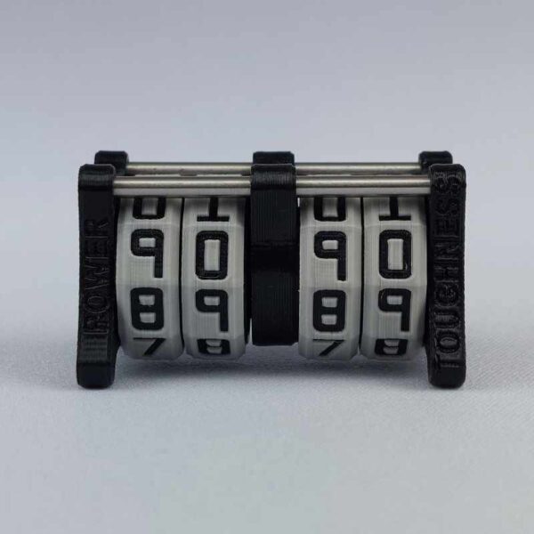 The CC-2x2 creature counter viewed from the front to clearly show the engraved words "power" and "toughness". This version shown is black with necro dagger and soul potion.