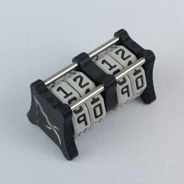 The CC-2x2 creature counter viewed from an isometric angle showing the top dials and side 1 dagger. This version shown is black with necro dagger and soul potion.