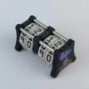 The CC-2x2 creature counter viewed from an isometric angle showing the top dials and side 2 soul potion. This version shown is black with necro dagger and soul potion.
