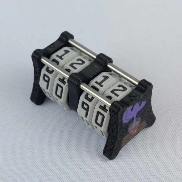 The CC-2x2 creature counter viewed from an isometric angle showing the top dials and side 2 soul potion. This version shown is black with necro dagger and soul potion.