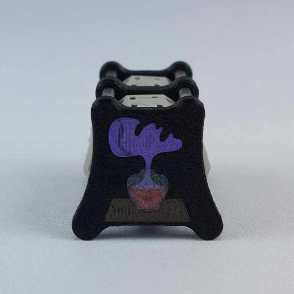 The CC-2x2 creature counter viewed from the right "toughness" side 2 to show the image of the soul potion bottle with purple soul face coming out. This version shown is black with necro dagger and soul potion.