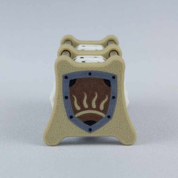 The CC-2x2 creature counter viewed from the right "toughness" side 2 to show the image of the shield with half-sun. This version shown is ivory white with great sword and sun shield.