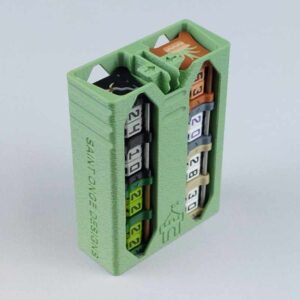 The CS-01 dial counter storage in a pistachio green color viewed from an isometric angle to show the top, front, and side. This deck storage container is shown full of number counters and creature counters to show how it is used.