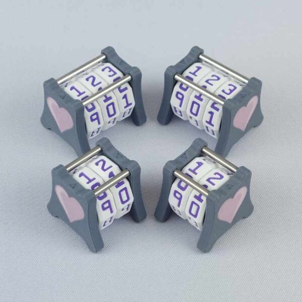 Two NC-2 and two NC-3 number counters grouped together to show the different size options and to show both side 1 and side 2 image designs in one photo. The version shown has a dark gray base and a pink heart in the middle on both sides 1 and 2.