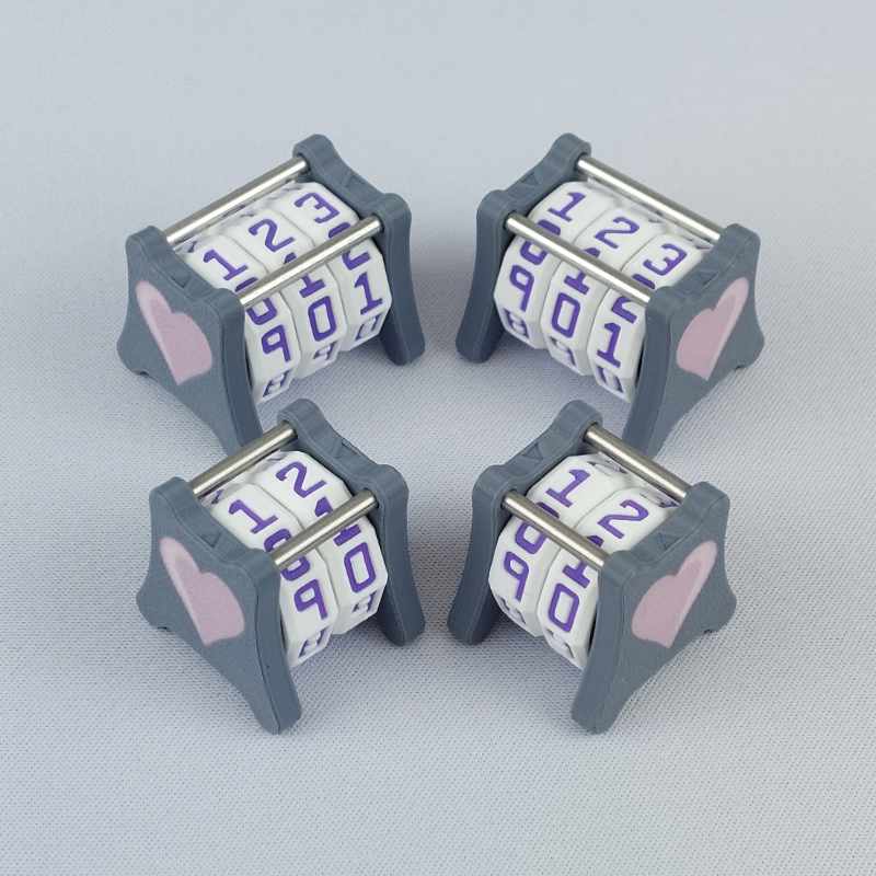Two NC-2 and two NC-3 number counters grouped together to show the different size options and to show both side 1 and side 2 image designs in one photo. The version shown has a dark gray base and a pink heart in the middle on both sides 1 and 2.