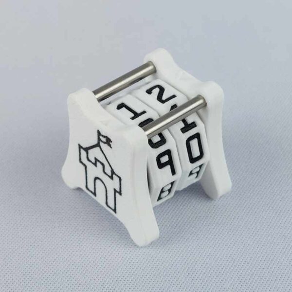 The NC-2 number counter viewed from an isometric angle showing the top dials and side 1 castle. The version shown has a white base with a black castle outline in the middle on both sides 1 and 2.
